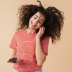 emotional-happy-excited-young-curly-woman-2JBV3GN.jpg